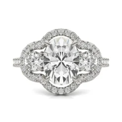 Oval Moissanite Three-Stone Ring With Halo In 14K White Gold